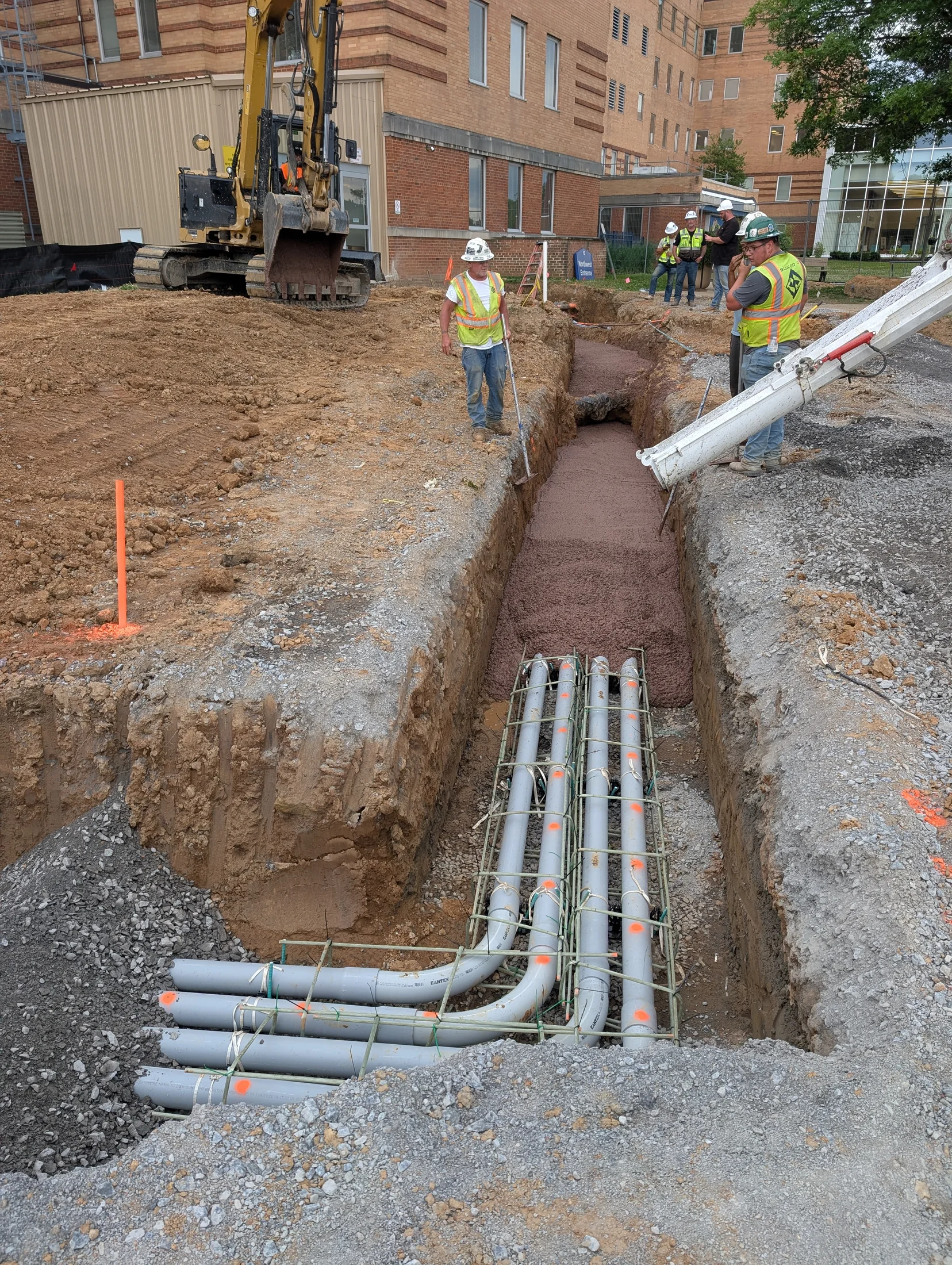 Electrical duct bank conduit entering a building trench