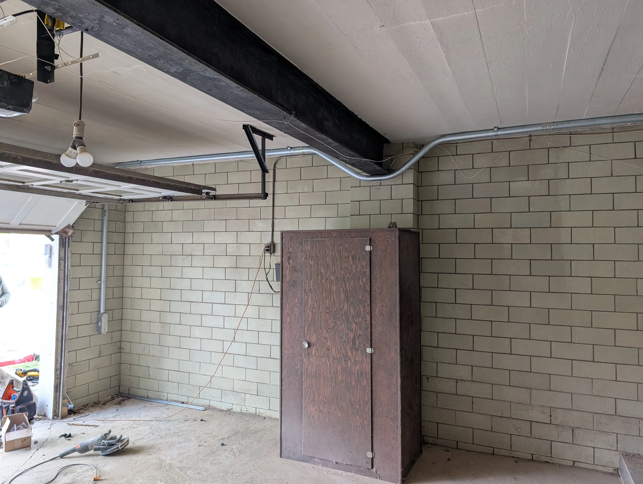 Electrical conduit installation in a masonry garage by State of the Arc Electric