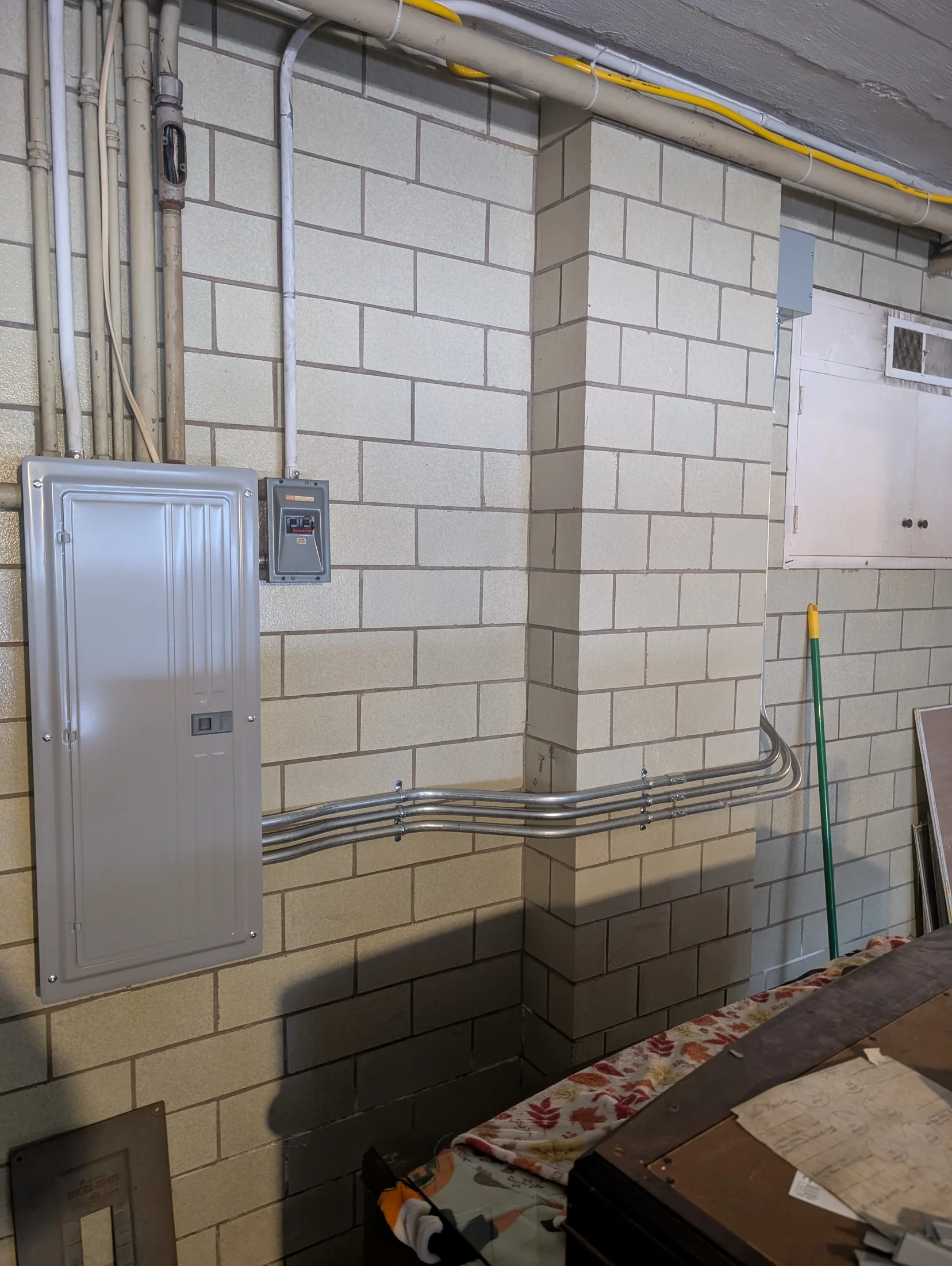 Electrical panel and surface-mounted EMT conduit installation by State of the Arc Electric
