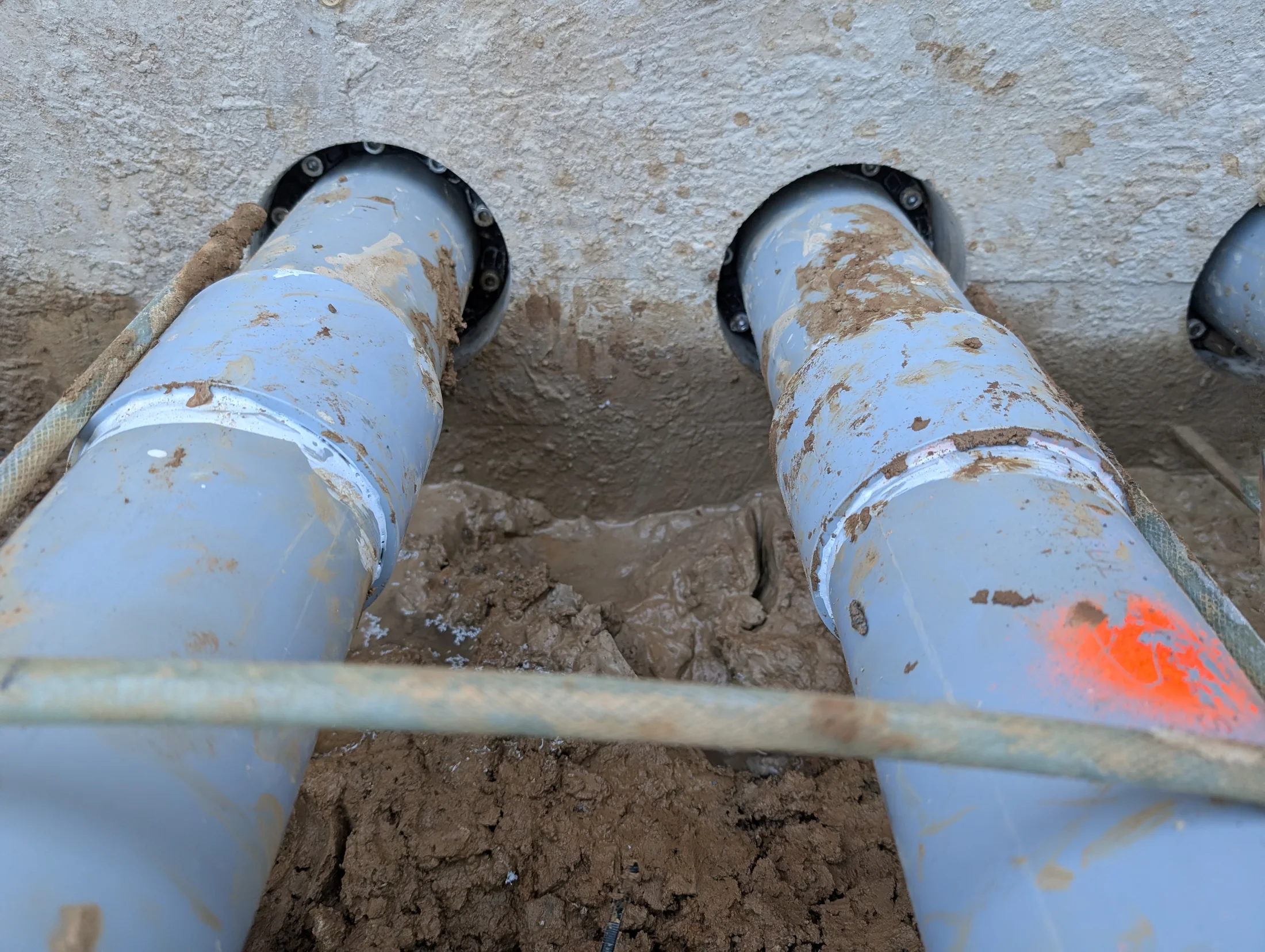 PVC electrical conduit penetrations through a concrete wall