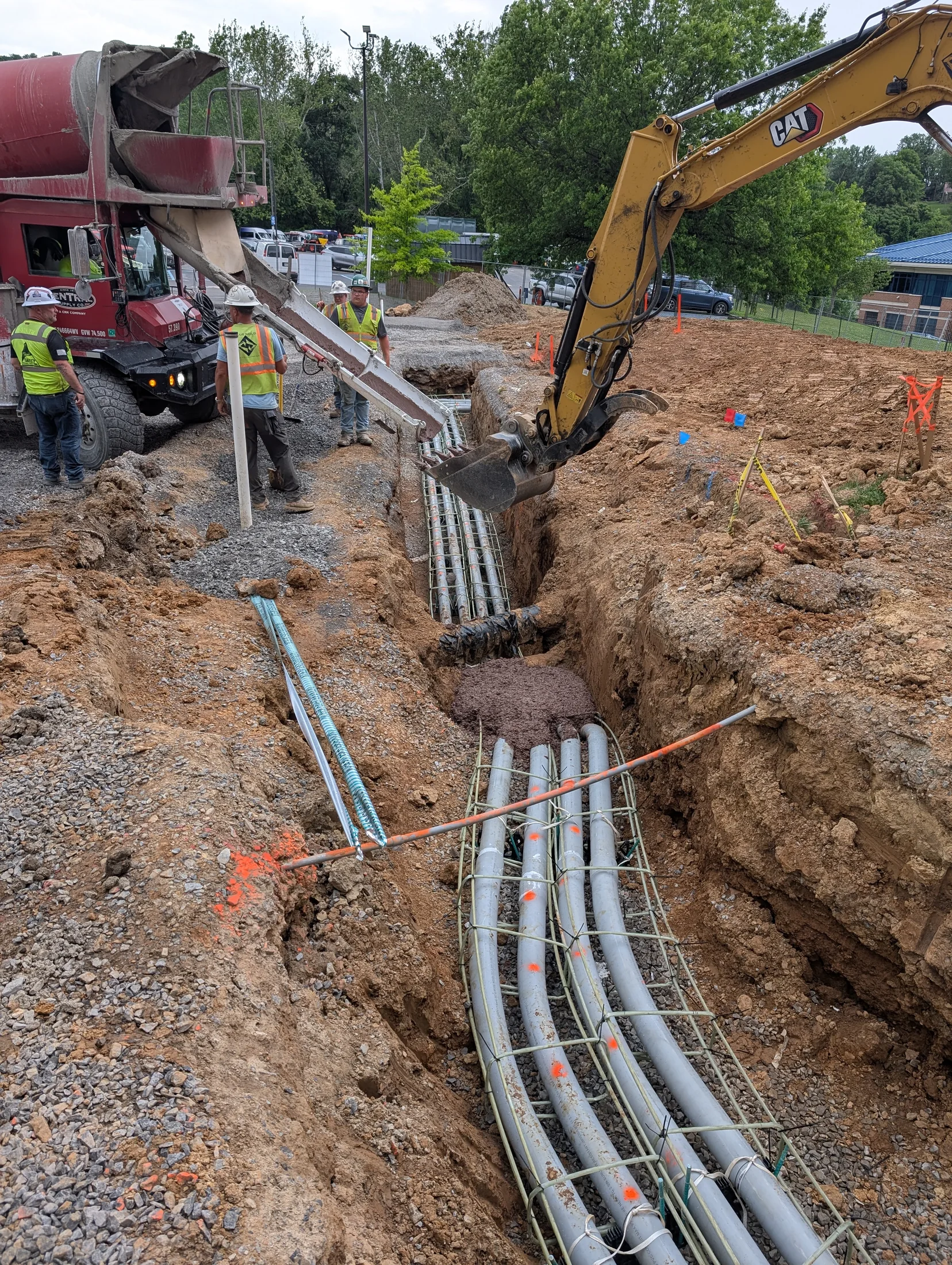 Underground electrical conduit installation with excavation equipment
